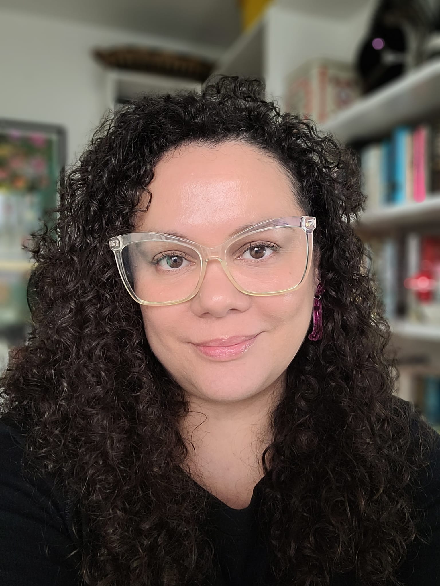 Image is of a Davinia - a woman of mixed heritage with curly dark hair and glasses.